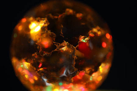crystal ball with red and orange reflections on a black background.の写真素材