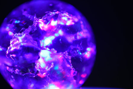 purple gemstone on a black background close-up macro photographyの写真素材