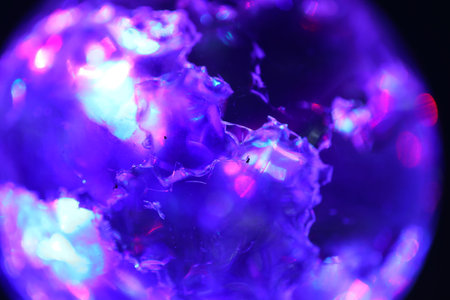 close up of a purple gemstone on a black background. macro