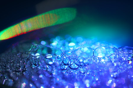 abstract macro of water drops on glass with bokeh backgroundの写真素材