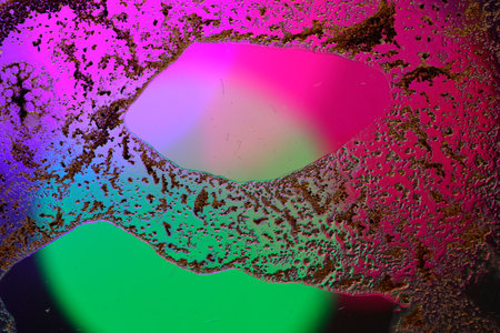 abstract background with color blots and stains on a glass surfaceの写真素材