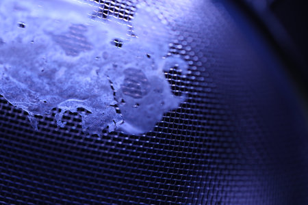 Close-up of water drops on a metal mesh. Macro.の写真素材