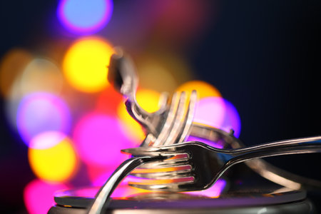 Spoon and fork on the background of a colorful bokehの写真素材