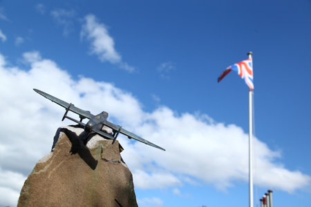 Plane on the rock with the flag of the United Kingdom in the backgroundの写真素材