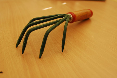 Garden tools on a wooden table. Rake and rake.の写真素材