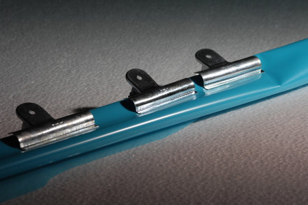 Close-up of a metal clips on a gray background. Shallow depth of field