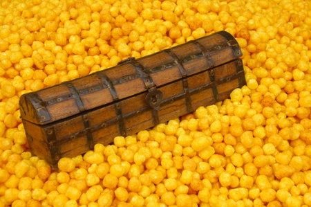 Wooden chest on a background of yellow corn, close-up