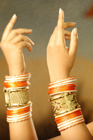 Hands of indian woman with bracelets on her hands.の写真素材