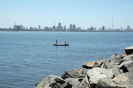 Fisherman in a boat on the coast of the city.