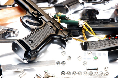 Pistol and bullets on a white background close-up.