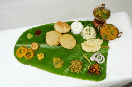 Indian food: Assorted Indian snacks on a green banana leaf.の写真素材