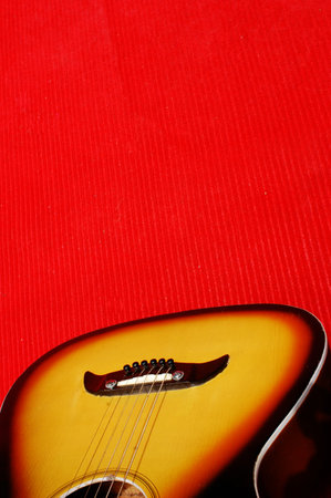 Guitar on a red background, close-up, top viewの写真素材