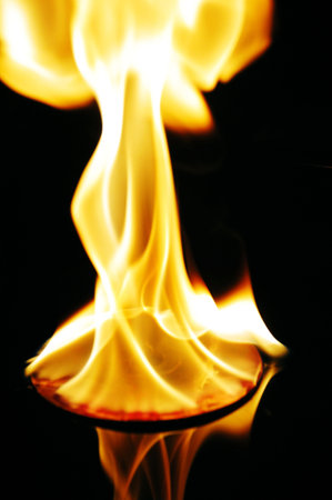 Fire flames on black background close-up macro photography, abstract texture
