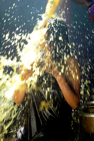 Young woman washing her hair in the shower with a stream of water