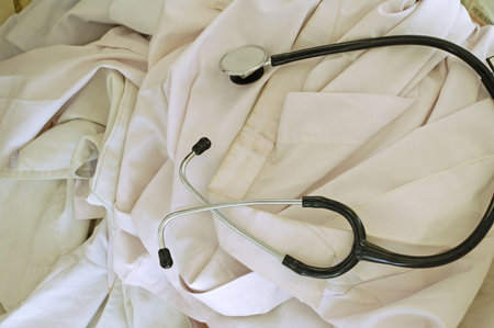 Stethoscope lying on the bed of a doctor or nurse.の写真素材