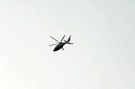 Military helicopter flies in the sky. Military aircraft. Airshow.の写真素材