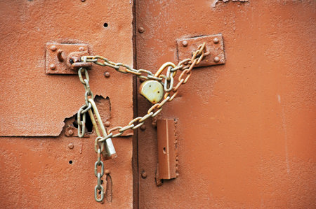 Old rusty padlock and chain on old rusty metal door with copy space
