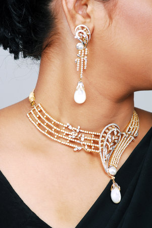 Beautiful woman wearing luxury necklace and earrings. Studio shot.の写真素材