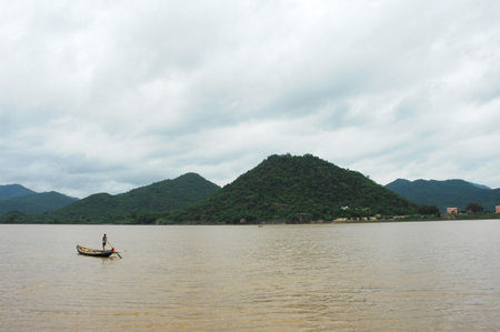 Fisherman in a boat on the Mekong River in Vietnamの写真素材