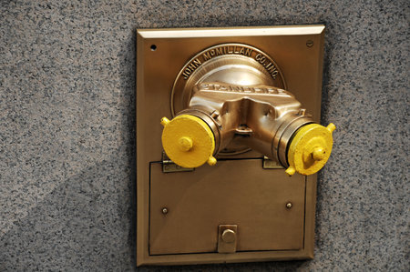 Vintage fire hydrant on the wall of the building, close-up