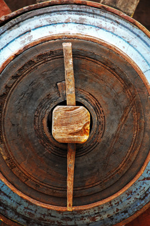 Old rusty padlock on the steel wheel, closeup of photo