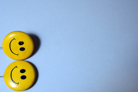 Smiley faces on a blue background. Positive and negative feelings.の写真素材