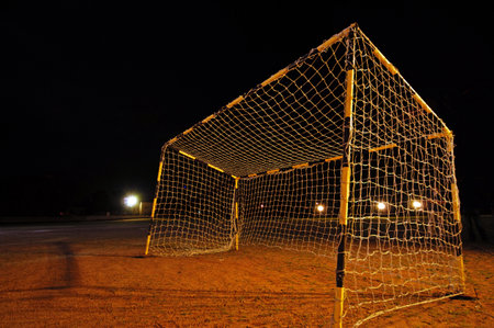 Soccer goal at night in the stadium, closeup of photoの写真素材