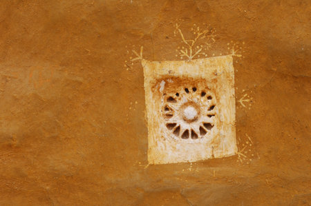 Close up view of an ancient sandstone carving on a wall.