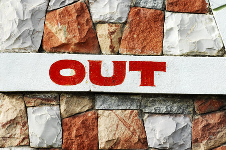 Out sign on a brick wall. Close-up. Selective focus.の写真素材