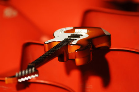 Acoustic guitar on a red background, close-up, selective focusの写真素材