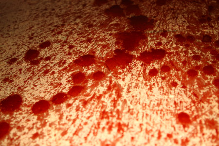 Blood stains on a red surface. Shallow depth of field.の写真素材