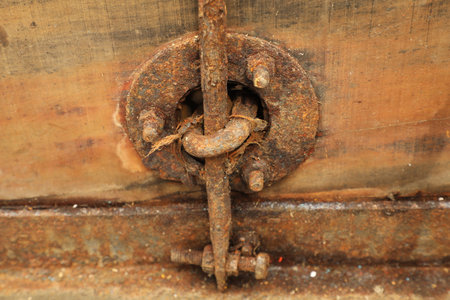 Rusty lock on the old wooden door, closeup of photoの写真素材