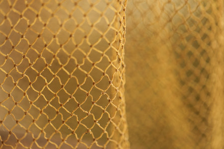 Close up of yellow netting. Abstract background and texture for design.