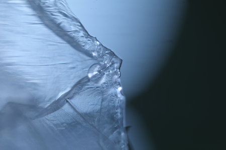 Transparent plastic bottle with water on a black background. Close-up.