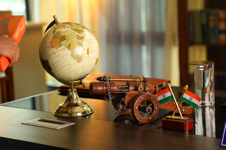 Antique gun and globe on the table in the library. Selective focus.の写真素材
