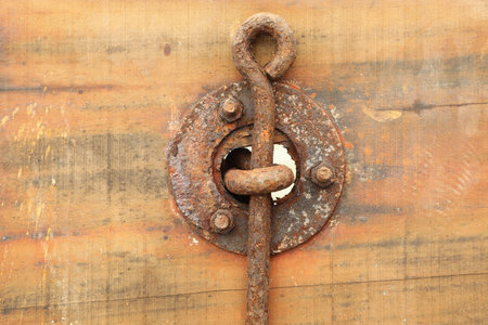 rusty lock on the old wooden door, closeup of photoの写真素材