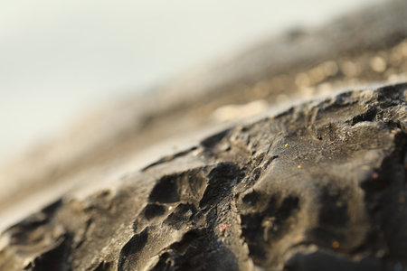 Tire tracks on the sand. Macro shot with shallow depth of field.の写真素材