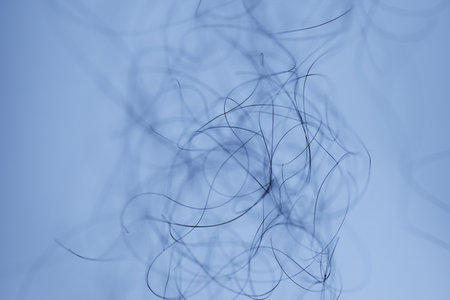 abstract blue background with curling lines, closeup of photoの写真素材