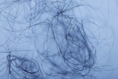 close up of hair strands on light blue background, beauty and fashion conceptの写真素材