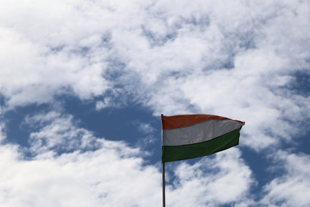 National flag against the blue sky with cloudsの写真素材
