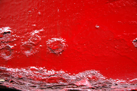 red paint on the wall as a background, closeup of photoの写真素材