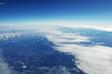 Aerial view of clouds and blue sky from the airplane window.の写真素材