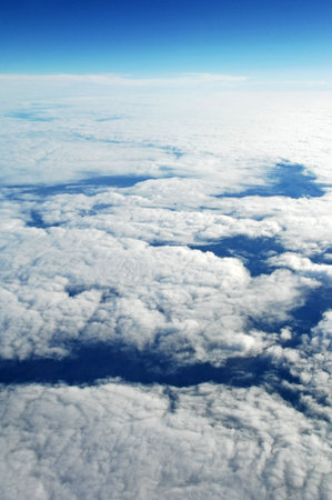 Aerial view of clouds and blue sky. View from airplane windowの写真素材