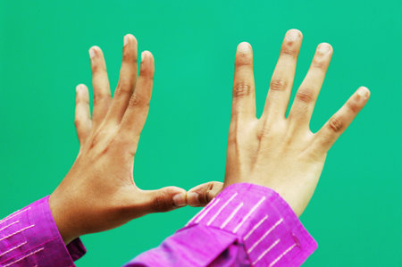 Close up of businesswoman hands gesturing with fingers on green backgroundの写真素材