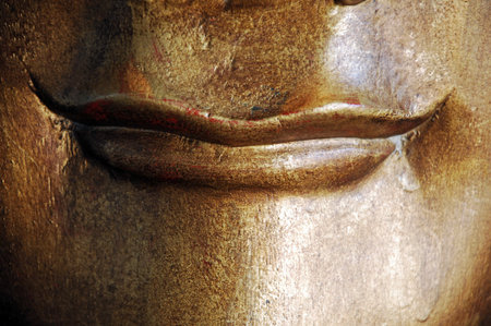 The face of the Buddha in the temple, closeup of photoの写真素材