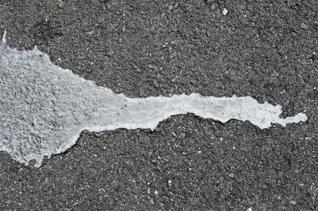 Asphalt texture with cracks and scratches. Abstract background and texture for design.の写真素材