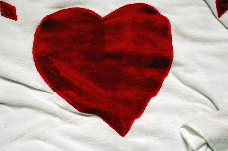 Red heart on white fabric texture background. Valentine's Day concept.の写真素材
