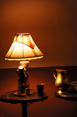 Vintage table lamp and cup of coffee on the black background.の写真素材