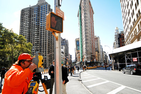Surveyors work on the streets of Manhattan. The city of New York is the most populous city in the...