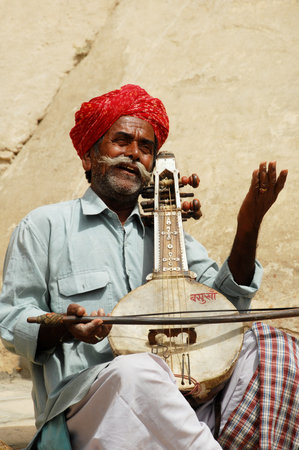 Unidentified Indian man playing the balalaika in Varanasi, India.